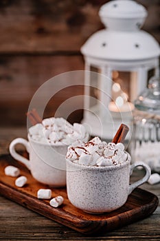 Christmas drink. Hot chocolate with marshmallows and cinnamon on dark wooden background.