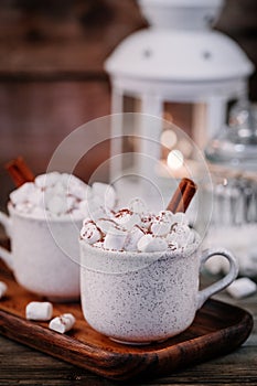 Christmas drink. Hot chocolate with marshmallows and cinnamon on dark wooden background.