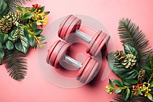 Christmas dumbbells flat lay with palm leaves. New Year new you, concept of sport, winter sale season, healthy lifestyle, gym