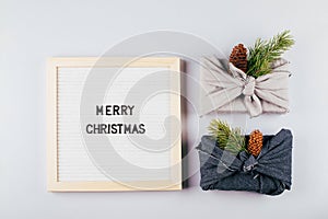 Christmas eco-friendly gift box furoshiki. Lightbox with text Merry Christmas. Zero waste concept