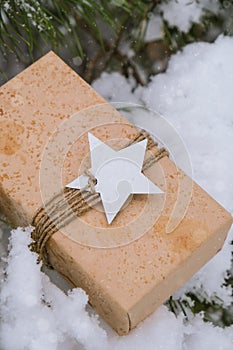 Christmas eco gift in rustic vintage style. Winter holidays mock up on snowy fir branch background. Zero waste, plastic