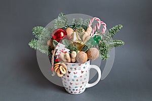 Christmas edible bouquet with nuts, sweets, nobilis and christmas decor in a cup