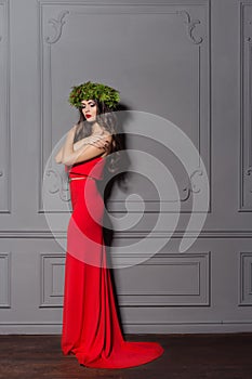 Christmas elegant fashion woman. Xmas New Year hairstyle and makeup. Gorgeous Vogue style Lady with Christmas decorations on her