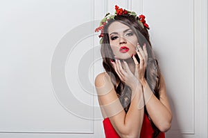 Christmas elegant fashion woman. Xmas New Year hairstyle and makeup. Gorgeous Vogue style Lady with Christmas decorations on her