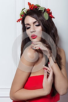 Christmas elegant fashion woman. Xmas New Year hairstyle and makeup. Gorgeous Vogue style Lady with Christmas decorations on her