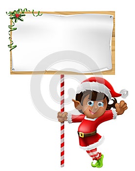 Christmas elf holding a sign