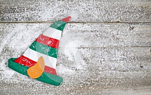 Christmas Elf Stocking on rustic wood with snow