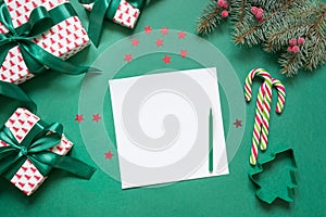 Christmas empty blank letter to Santa or invitation on green. Top view