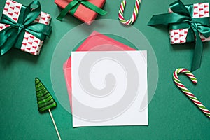 Christmas empty blank letter to Santa or invitation on green. Top view