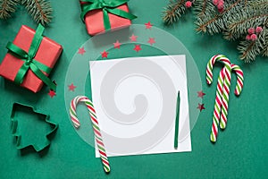 Christmas empty blank letter to Santa or invitation on green. Top view