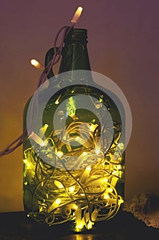 Christmas enchanting lights in a glass jar of green color, glowi