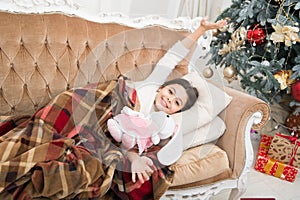 Christmas eve. Dreaming about christmas miracle. Small cute girl dreaming about christmas gift. Happy childhood. Small