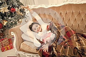 Christmas eve. Dreaming about christmas miracle. Small cute girl dreaming about christmas gift. Happy childhood. Small