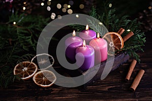 Christmas eve, four purple burning advent candles