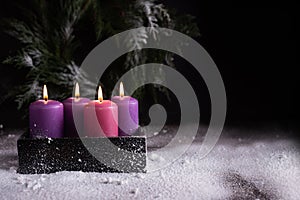 Christmas eve, one pink and three purple advent candles
