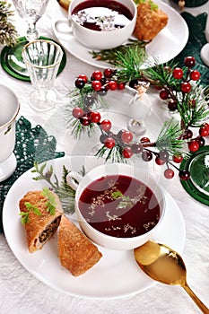 Christmas Eve table with red borscht and croquettes