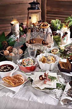 Christmas Eve table with traditional dishes and cakes