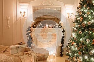 Christmas evening by candlelight. classic apartments with a white fireplace, decorated tree, bright sofa, large windows