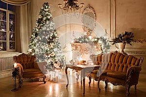 Christmas evening by candlelight. classic apartments with a white fireplace, decorated tree, sofa, large windows and