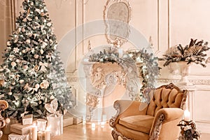 Christmas evening by candlelight. classic apartments with a white fireplace, decorated tree, sofa, large windows and