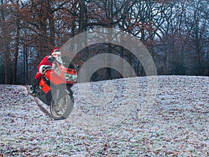 Christmas evening. Santa Claus on a red motorcycle rides through the winter forest. The concept of a modern lifestyle. Place for