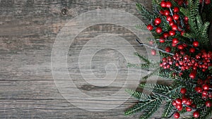 Christmas Evergreen Branches and Berries Over Rustic Wood Horizontal Background photo