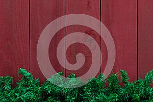 Christmas evergreen tree garland border with antique red wood background