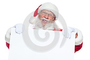 Christmas. Evil Santa Claus in white gloves with his tongue sticking out holds an empty white cardboard and shows faces