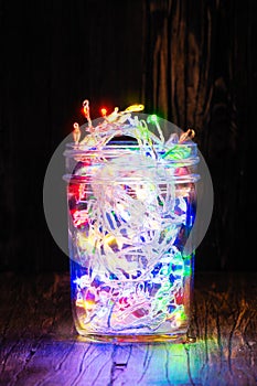 Christmas fairy lights in a glass jar. Home x-mas decor concept