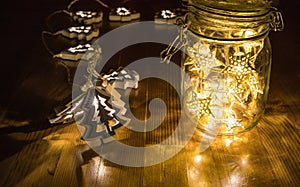 Christmas fairy lights in a mason jar, glowing in the dark, fairy lights in mason jar with selective focus, glitter overlay