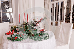 Christmas Family Dinner Table Concept.Table setting for new year dinner.decorations, candles and lanterns. white