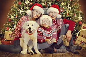 Christmas Family and Dog Under Xmas Tree, Happy Mother Father Child Portrait in Red Hats