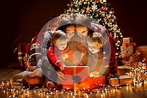 Christmas Family open Lighting Present Gift Box under Xmas Tree, Happy Mother Father Children