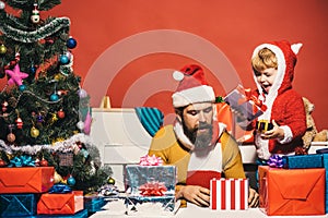 Christmas family opens presents on dark red background
