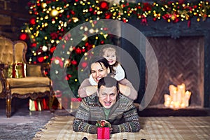 Christmas family portrait with decorated Christmas tree