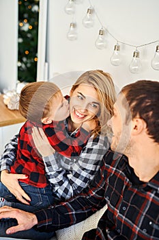 Christmas family spending time together in bed at home.