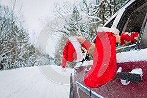 Christmas family travel by car, family with santa hat and socking on road in snow photo