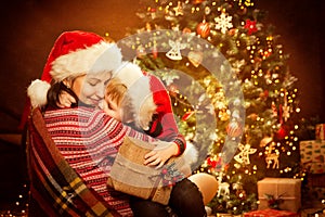 Christmas Family and Xmas Tree, Happy Mother give Baby Child New Year Present Gift photo