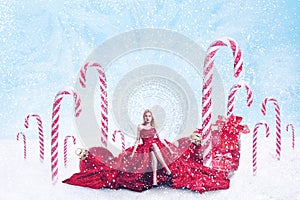 Christmas fantasy portrait of young woman with gift boxes