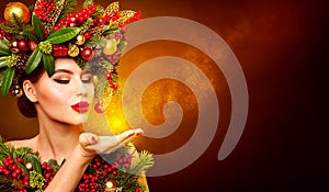 Christmas Fashion Model Beauty Makeup, Wreath Hairstyle. Xmas Woman Blowing to Hand, Beautiful Artistic Portrait