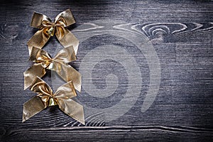 Christmas festal goldish bows on wooden board