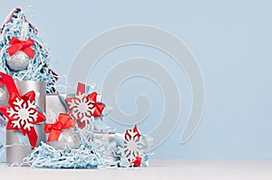 Christmas festive background for advertising and design - decorative red and blue fir tree with glittering balls and gift boxes.