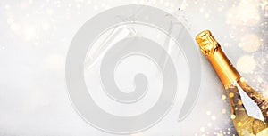 Christmas festive background with champagne bottle and wine glasses, golden christmas balls and decor, top view banner