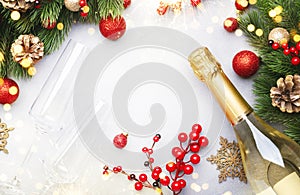 Christmas festive background with champagne bottle and wine glasses, golden and red christmas balls, fir branches and decor, top