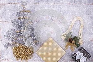 Christmas festive background with fir tree decorated with decor, boxes with padarkas on the snow, festive background