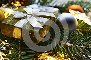 Christmas festive decoration with fir tree, golden gift box,garland lights and glittering balls.