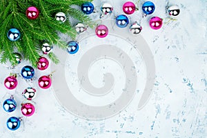 Christmas festive frame, New Year decorative corner border, shiny silver, pink, blue balls decorations, fir branches on light icy