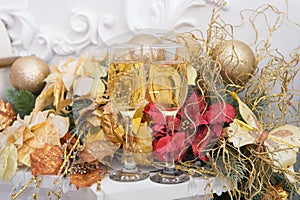 Christmas, festive mood. two glasses of champagne and Chrismass decoration. Two glasses with vine in holiday decoration.