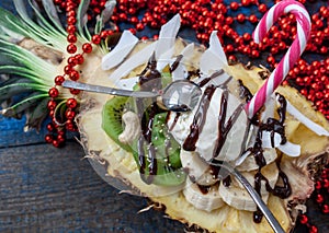 Christmas festive pineapple cut in half with a scoop of ice cream