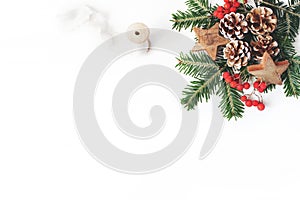 Christmas festive styled composition. Decorative banner. Pine cones, fir tree branches, red rowan berries, wooden stars